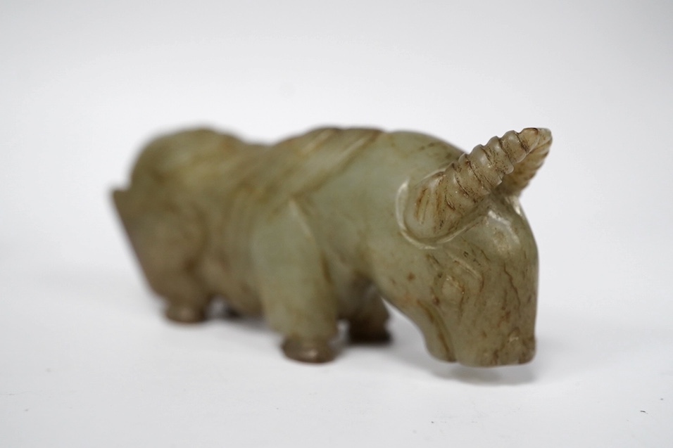 A Chinese white and black jade pendant now hollowed as a snuff bottle, and a Chinese celadon jade figure of a buffalo. Condition - fair to good